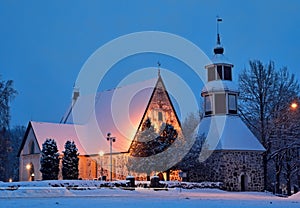 A medieval church illuminated in winter evening