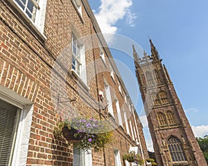 Medieval Church Tower next to Red Brick Georgian Building