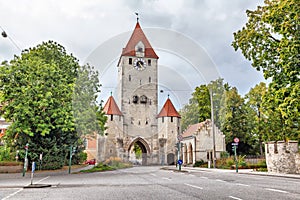 Medieval city gate with clock tower in Regensburg photo