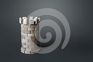 Medieval defense tower on a gray background. Safety, life and property insurance. The concept of resilience and strength.