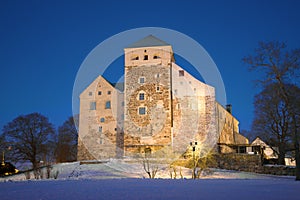 The medieval episcopal castle of the city of Turku, February twilight. Finland