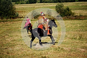 Medieval equestrian robber chases the horseback woman