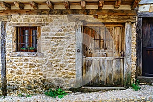 Medieval facade of stone house in Calatanazor, Soria, Spain.
