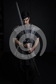 Medieval or fantasy character in leather jerkin and holding weapons