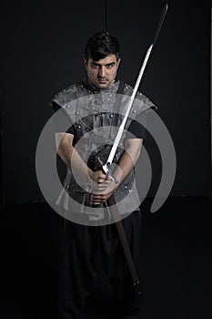 Medieval or fantasy character in leather jerkin and holding weapons