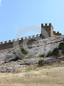 A medieval fortress on a stone rock.