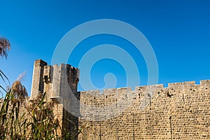 Medieval fortress tower under a blue sky in La Camargue, France