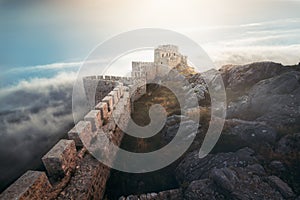 Medieval fortress, wall and tower landscape with cloudy sky.