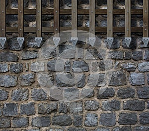 Medieval gate bars on castle stone wall