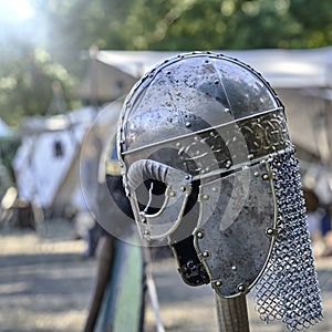 Medieval helmet with circumferential decoration and protective elements for the ears and neck