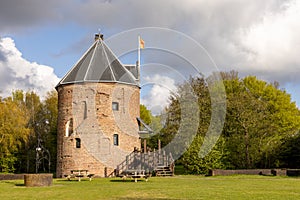 Medieval house Dever in Lisse, with flag and cloudy sky.