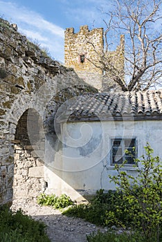 Medieval house, wall and tower of Genoese fortress in the city of Feodosia on the Crimean Peninsula, built by colonists from Genoa