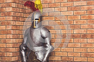 Medieval knight armor against the background of a brick wall