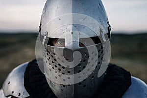 Medieval knight in armor and helmet closeup view