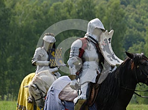 Medieval knight in armor on horseback