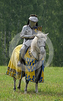 Medieval knight in armor on horseback