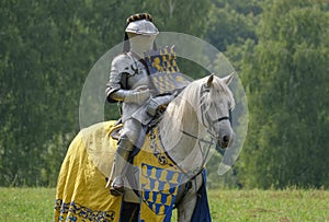 Medieval knight in armor on horseback