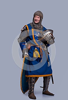 Medieval knight with helmet in his hand