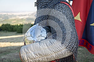 Medieval knight holding his helmet, reenactment demonstration and recreation