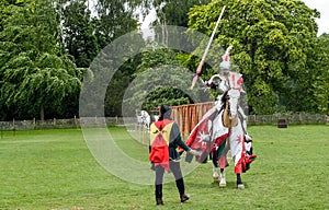 A medieval knight and horse in armour and costume for a joust photo