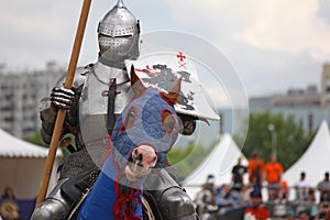 Medieval knight on horse in heavy protection