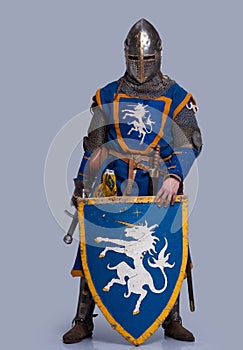 Medieval knight with shield in front of him photo