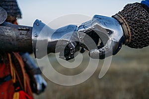 Medieval knights hands in metal gloves