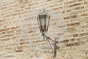 Medieval lantern on the brick wall