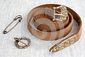 Medieval: leather belt, fibula, pin. Scandinavian, Slavic ornament.