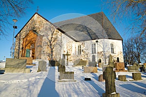 Medieval Lutheran church in the city cemetery on a sunny February day. Halikko, Finland