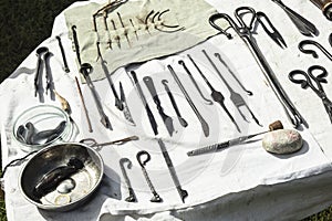 Medieval medical instruments on a table.