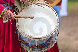 Medieval minstrel playing drum photo