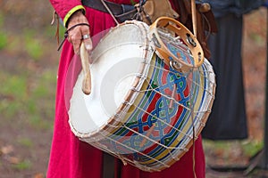 Medieval minstrel playing drum photo