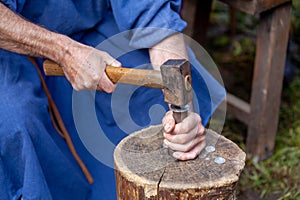 Medieval minter minting a coin photo