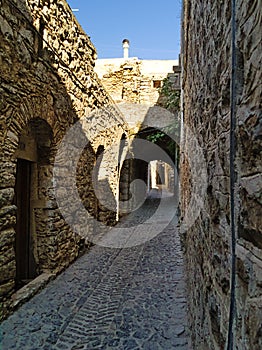 Medieval narrow cobblestone alley diminishing perspective