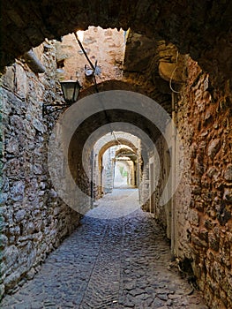 Medieval narrow cobblestone alley diminishing perspective