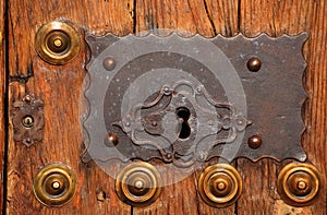 Medieval oak door and bronze lock. Caceres, Spain. UNESCO World Heritage Site.