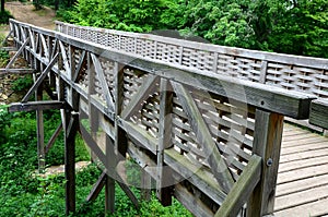 Medieval oak wood, bolted. Bridge over the moat. the railing is made of massive beams, between which several thin oak rods are wov