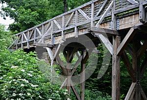 Medieval oak wood, bolted. Bridge over the moat. the railing is made of massive beams, between which several thin oak rods are wov