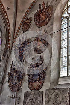 Medieval old family coat of arms hanging on the wall