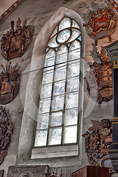 Medieval old family coat of arms hanging on the wall