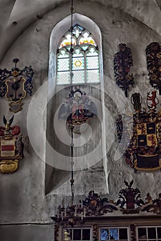 Medieval old family coat of arms hanging on the wall