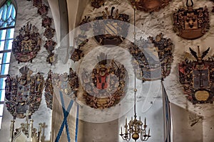 Medieval old family coat of arms hanging on the wall