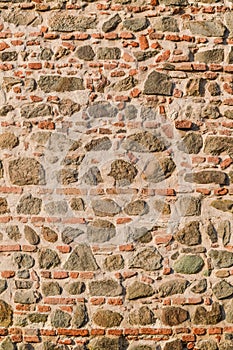 Medieval old wall made of stones and bricks