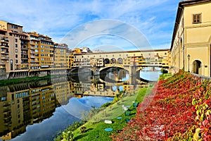 Medieval Ponte Vecchio with reflections during autumn, Florence, Tuscany, Italy