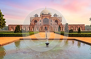 Medieval red sandstone medieval architecture Humayun Tomb complex Delhi at sunset.
