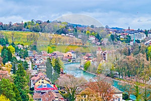 Medieval residential houses on the bank of Aare river in surrounding of lush grenery in Bern, Switzerland