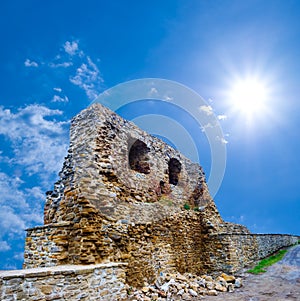 medieval ruined castle wall under a sparkle sun