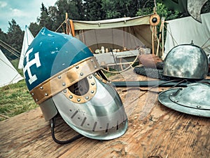 Medieval scene. Medieval knight attributes are helmet, chain mail, shield buckler, sword, halberd. Reconstruction of medieval life