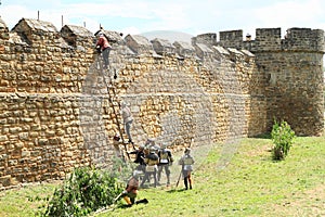Medieval soldiers climbing ladder on The Battle of Budyne